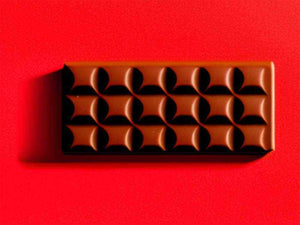 Cioccolato dark chocolate pieces stacked on white background