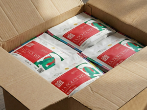 A cardboard box containing multiple bags of specialty coffee from Garage Coffee Bros featuring 'La Dolce Vita' blend.