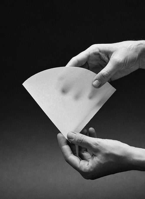 White Sibarist CONE conical coffee filter held open to show paper texture